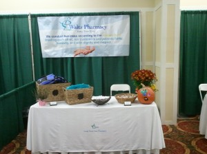 Waltz Pharmacy booth with complimentary lunch bags, ChapStick, hot/cold compacts and candy.