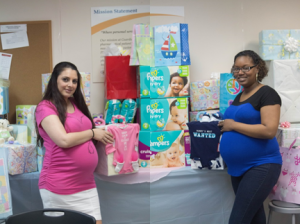 From l to r:  Madlena Emirzian, Guardian SEFL data entry technician, and  Landia Valdez, Guardian SEFL data entry supervisor, enjoy their baby shower with their coworkers. 