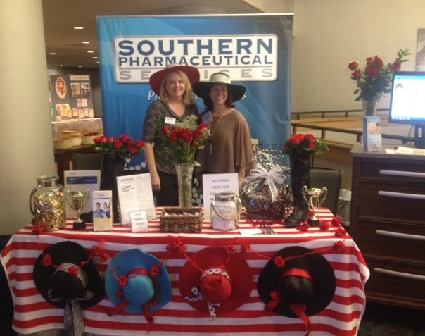      Terri Payne and Tess Davis rocking their derby hats and roses at the Southern Pharmaceutical Services booth.