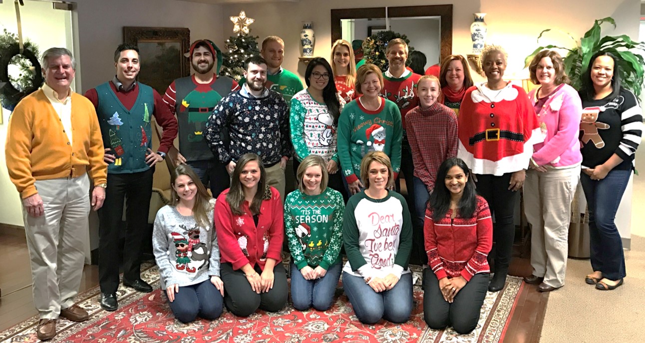 A few of our team memebers showing off their tacky Christmas sweaters!